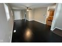 Living room with dark hardwood floors and kitchen view at 835 E Berwyn St, Indianapolis, IN 46203