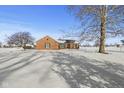 Brick ranch house with snowy yard and mature trees at 8796 W 800 S, Pendleton, IN 46064