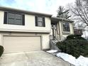 Tan two-story house with a garage and manicured landscaping at 9518 Bay Vista E Dr, Indianapolis, IN 46250