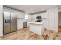 Modern kitchen with white cabinets, stainless steel appliances, and an island at 10767 Red Pine Dr, Fishers, IN 46037