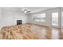 Bright living room with hardwood floors, fireplace, and white shiplap wall at 10767 Red Pine Dr, Fishers, IN 46037