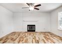 Living room features hardwood floors, fireplace, and shiplap accent wall at 10767 Red Pine Dr, Fishers, IN 46037