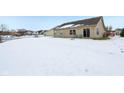Snow-covered backyard with view of neighboring homes at 11537 Jagged Rock Ct, Fishers, IN 46037