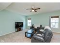 Living room with dark leather furniture and a large TV at 15256 Harmon Pl, Noblesville, IN 46060