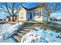 Steps leading to charming home's entrance, snow on ground at 207 E Ohio St, Fortville, IN 46040
