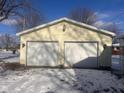 Detached two-car garage with white doors and light fixtures at 208 Winding Dr, Alexandria, IN 46001