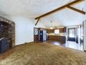 Open concept kitchen with wood cabinets, stainless steel appliances, and brick flooring at 2584 W Mercer Ln, Pendleton, IN 46064