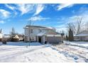 Two-story house with gray siding, attached garage, and snowy yard at 2911 Braxton Ct, Indianapolis, IN 46229