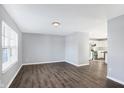Open concept living room with kitchen view and dark gray vinyl flooring at 2911 Braxton Ct, Indianapolis, IN 46229