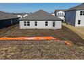 The house has a gray exterior with a walkout basement and is surrounded by green space at 3221 W Keepsake Ln, Monrovia, IN 46157