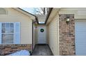 Side entrance with brick accents and a wreath on the door at 3459 Lauren Dr, Indianapolis, IN 46235