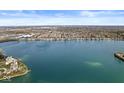 Beautiful aerial view of a lakefront community with stunning blue water and clear skies, offering a serene living environment at 3543 Clearwater Cir, Indianapolis, IN 46240