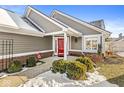 Red front door entry with walkway and landscaping, gray siding home at 3543 Clearwater Cir, Indianapolis, IN 46240