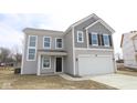 Charming two-story home showcasing a two-car garage and appealing gray siding at 3945 Highcrest Rd, Indianapolis, IN 46239
