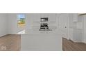 Modern kitchen with white cabinetry, stainless steel appliances, and a center island at 5144 Rolling Meadow Blvd, Indianapolis, IN 46237