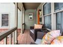 Inviting front porch with wicker chairs and colorful pillows at 634 E Vermont St, Indianapolis, IN 46202