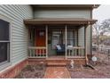Inviting front porch features a cozy seating area and a welcoming entrance, perfect for relaxing outdoors at 634 E Vermont St, Indianapolis, IN 46202