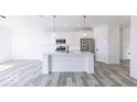 Modern kitchen with white cabinets, stainless steel appliances, and a large island at 6752 W Buck Stone Dr, McCordsville, IN 46055