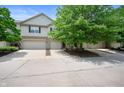 Inviting townhome community featuring attached garages, well-maintained driveways, and mature trees at 7042 Tyler Ln, Indianapolis, IN 46217