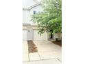 Attractive townhouse featuring an attached garage, well-maintained landscaping, and a welcoming entrance at 7042 Tyler Ln, Indianapolis, IN 46217