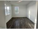 Bright bedroom with hardwood floors and two large windows at 7824 Magnolia St, New Palestine, IN 46163
