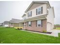 Attractive two-story home with a well-maintained lawn and an attached two-car garage at 7824 Magnolia St, New Palestine, IN 46163