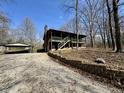 Charming cabin home with wraparound porch, two-car garage and landscaping, on a sunny day at 7887 Elk Dr, Nineveh, IN 46164