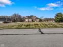 Brick home with a large grassy yard and paved road at 8152 Cottonwood Dr, Martinsville, IN 46151