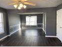 Dining room features dark hardwood floors, gray walls, and wainscoting at 8531 Friendship Ln, Indianapolis, IN 46217