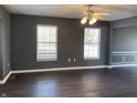 Spacious dining room with dark hardwood floors and gray walls at 8531 Friendship Ln, Indianapolis, IN 46217