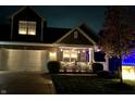 Two-story home at night with festive lights and landscaping at 8737 Twain Ln, Indianapolis, IN 46239