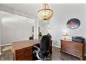 Home office features a large wooden desk, built-in shelving, and hardwood floors at 9847 Gallop Ln, Fishers, IN 46040