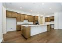 Open concept kitchen with large island, double ovens, and hardwood floors at 12507 Pasco St, Fishers, IN 46038