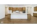 Spacious kitchen island with white quartz countertop and light wood cabinets at 12507 Pasco St, Fishers, IN 46038