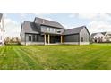 Large backyard with a grassy area and a partially visible patio at 14028 Grannan Ln, Carmel, IN 46074