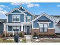 Two-story home with blue siding, brick accents, and a welcoming front porch at 1574 Mairn Ave, Carmel, IN 46032