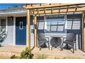 Inviting front porch with pergola, small table, and chairs at 1654 Iowa St, Indianapolis, IN 46203