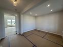 Bright living room featuring white walls and trim, recessed lighting, and an open entryway at 19962 Stone Side Ct, Westfield, IN 46074