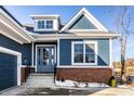 Stylish blue home exterior featuring brick accents, a covered entry, and a modern, inviting design at 20188 Hampton Park Dr, Westfield, IN 46074