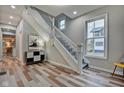 Bright entryway with hardwood floors and elegant staircase at 2450 Carrollton Ave, Indianapolis, IN 46205