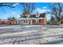 Brick ranch house with a red door, two-car garage, and snowy yard at 2934 S Irwin St, Indianapolis, IN 46203