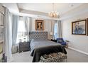 Elegant main bedroom with a tufted headboard, large windows, and artwork at 3844 Albert Ln, Bargersville, IN 46106