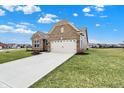 Inviting brick home with a two-car garage, nestled on a well-maintained lot in a friendly neighborhood setting at 3844 Albert Ln, Bargersville, IN 46106