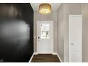 Bright entryway with dark accent wall, stylish lighting, and a white front door with a glass pane at 3844 Albert Ln, Bargersville, IN 46106