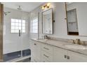 This bathroom features a double sink vanity, white subway tile, and a glass enclosed shower at 386 White Oak Ln, Greenwood, IN 46142