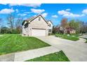 Charming two-story brick home with well-manicured lawn and two-car garage at 386 White Oak Ln, Greenwood, IN 46142
