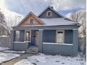 Charming gray house with wood accents and snowy yard at 416 N Grant Ave, Indianapolis, IN 46201