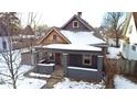 Gray house with wood accents, covered in snow at 416 N Grant Ave, Indianapolis, IN 46201