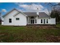 Back exterior of home featuring siding, a back patio, windows, and a chimney at 4232 Bunting Ln, Columbus, IN 47203