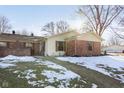 Brick ranch home with partial snow cover at 4314 London Ct, Anderson, IN 46013